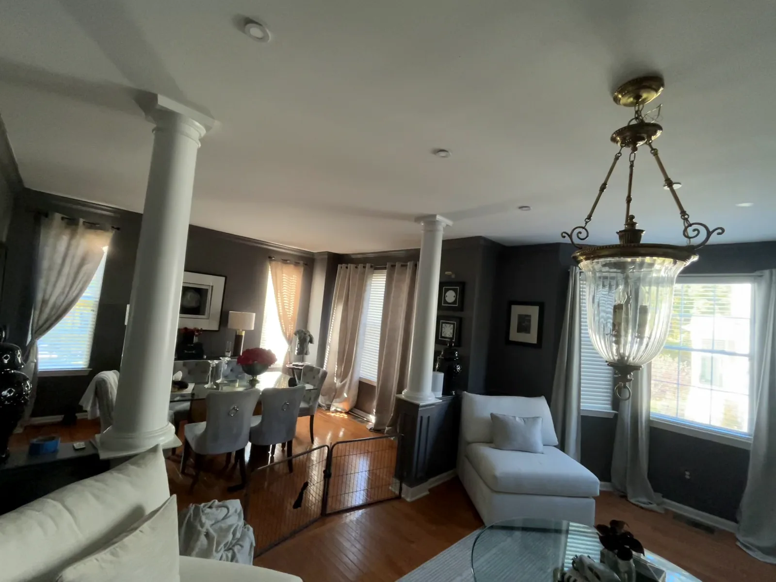 Dining area behind white columns with fresh gray walls